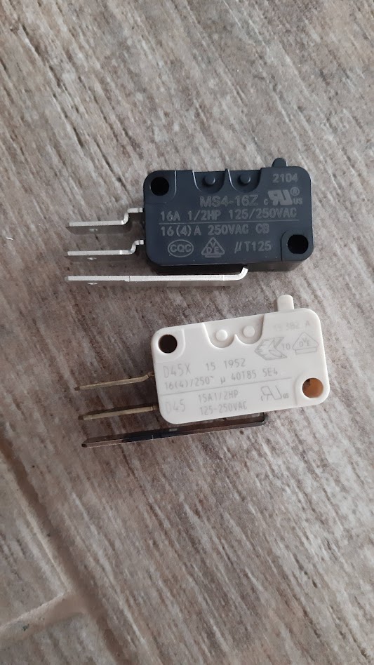 2 microswitches, upper is black, lower is white