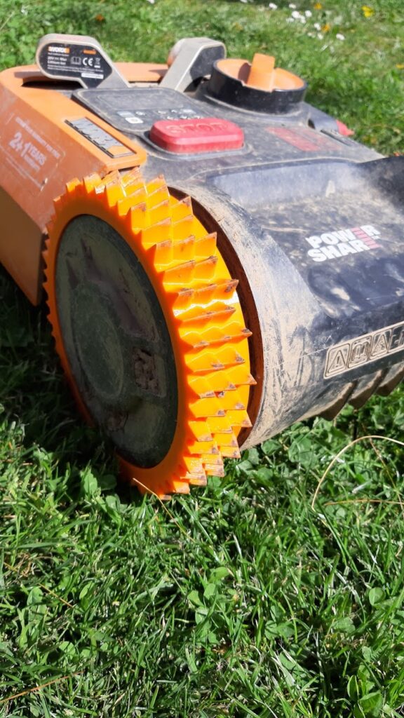 lawnmower wheel mounted, orange wheel, orange lawnmower