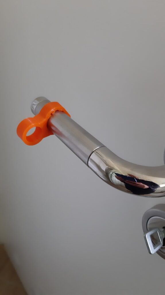 door stopper in orange tpu, mounted on a door handle