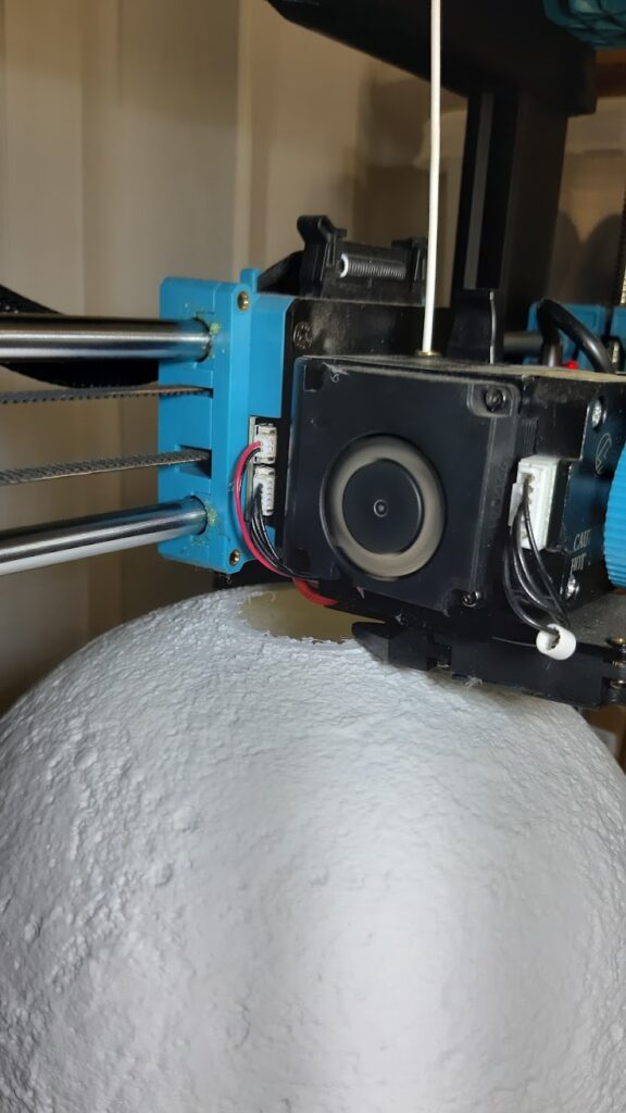 3d printer printing moon in white pla, the final stage