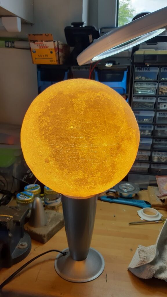 moon lamp assembled, glowing yellowish