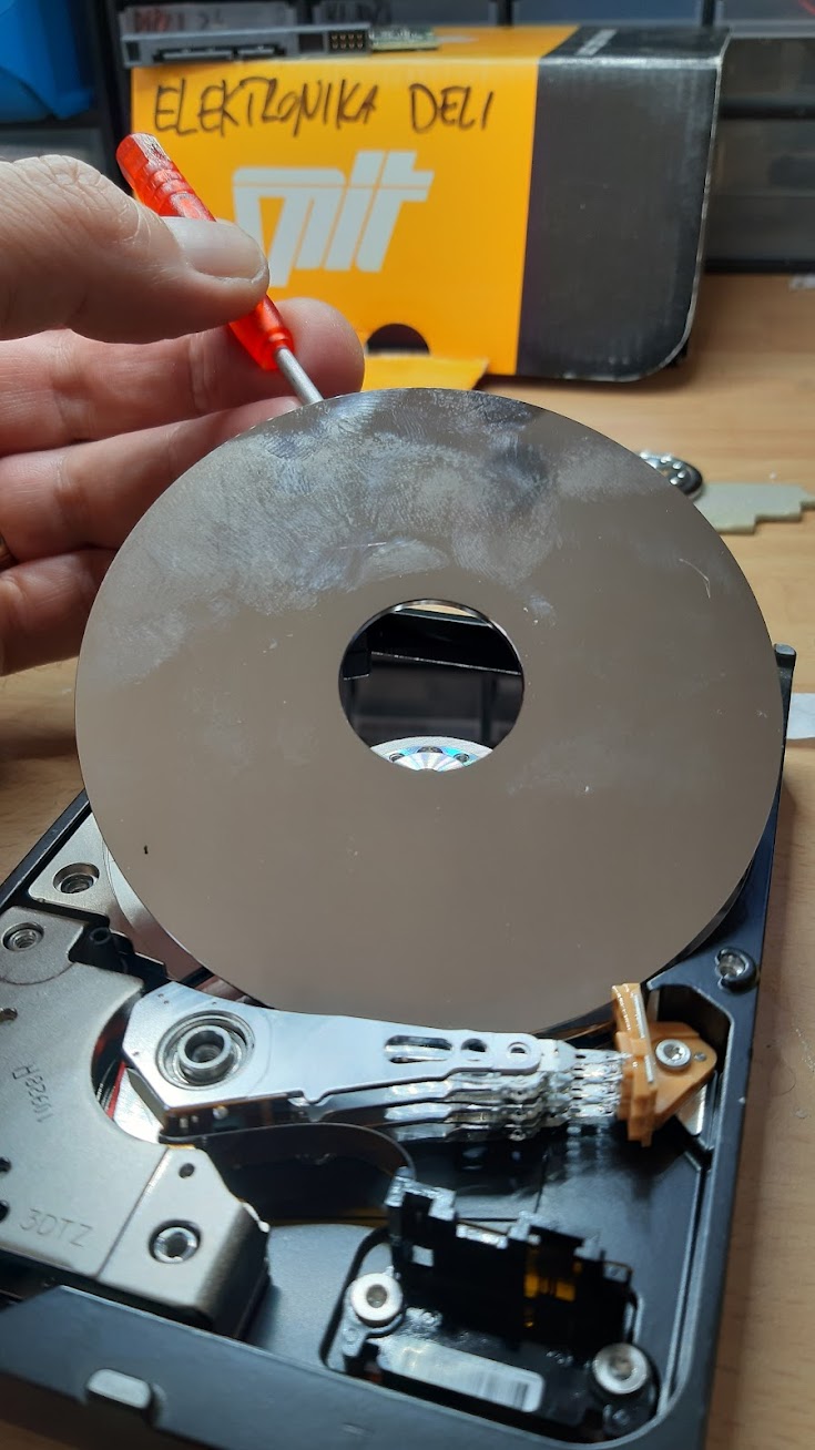 western digital 2 TB hard drive opened and a rotating plate lifted